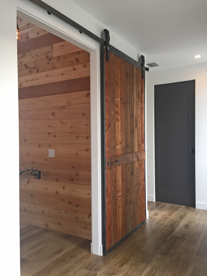 Upstairs sliding barn door at the Palm Modern Farmhouse. This door was fabricated with steel and wood from the original house.